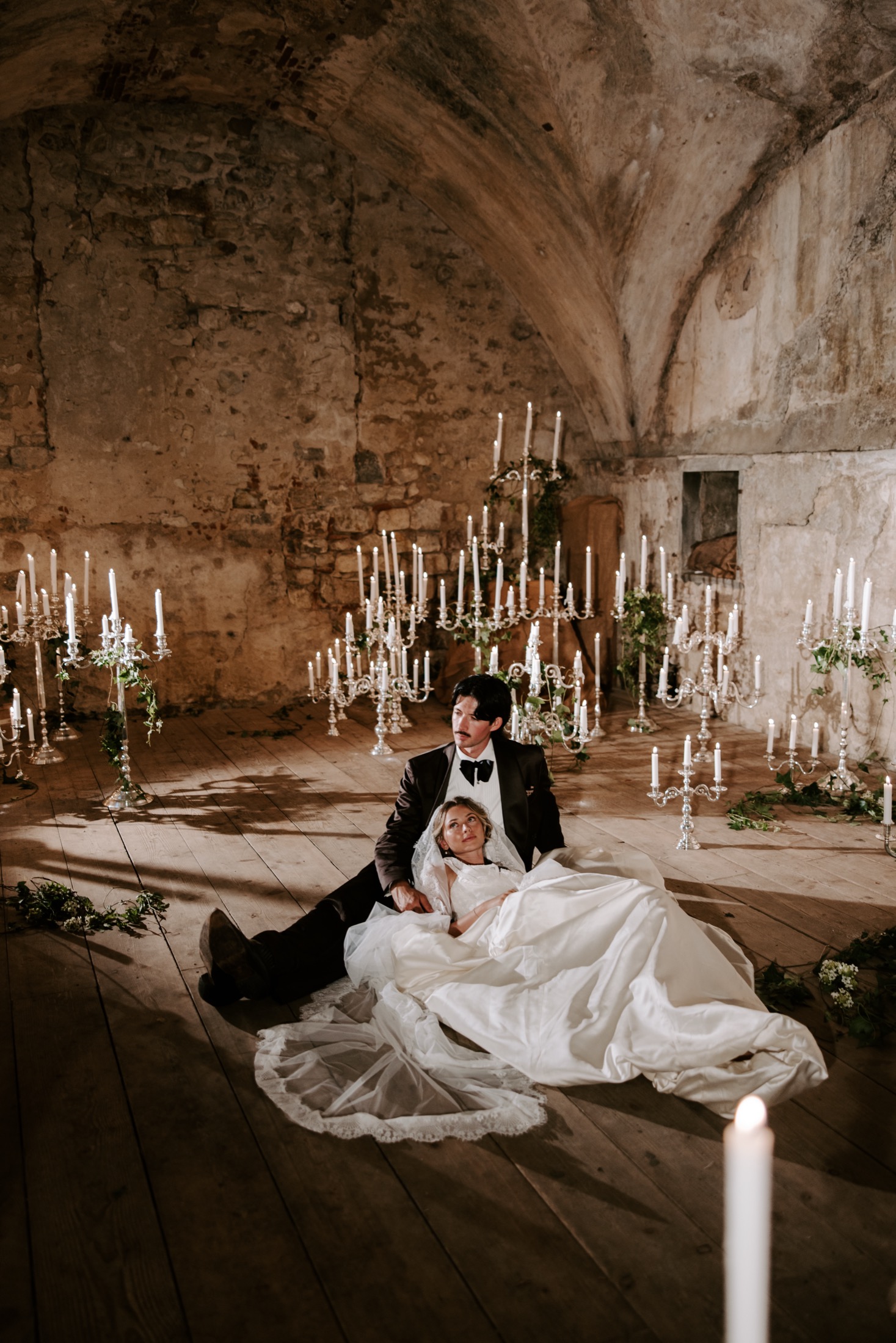 Bride and groom surrounded by candlelight in an Italian stone villa