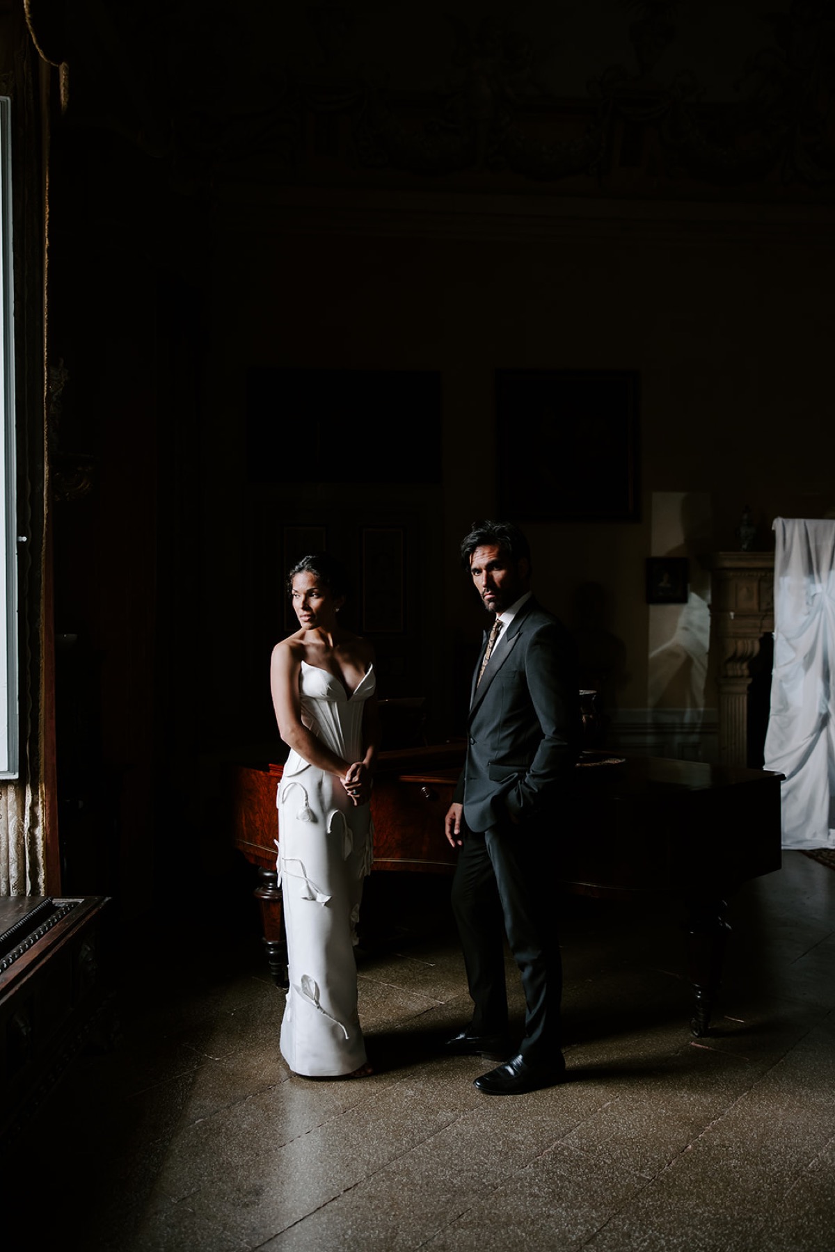 Bride and groom in a window-lit wedding portrait