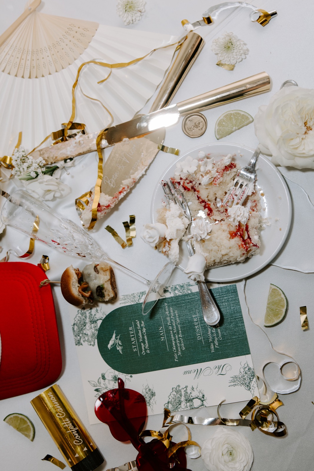 Wedding reception details with cake, gold confetti, and red sunglasses