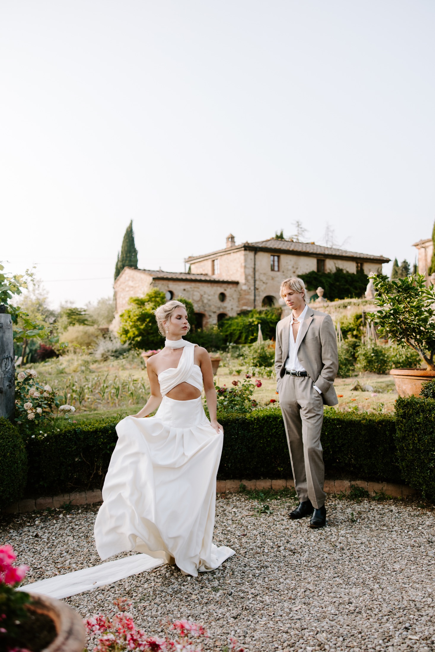 Couple in the gardens of a stone villa in Italy
