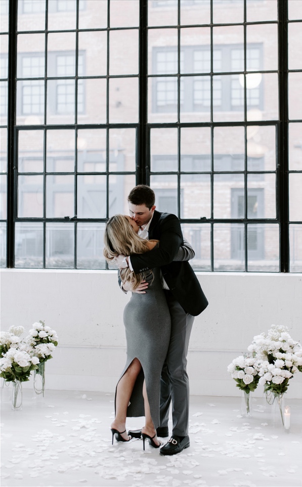 The couple embracing after the proposal
