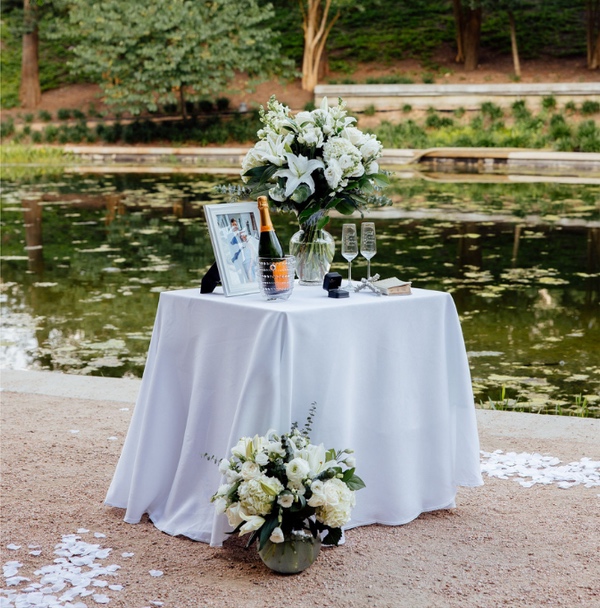 Flowers and champagne set up for a garden proposal